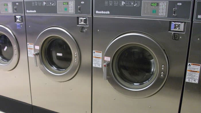 Commercial front-loading washers in a laundry room